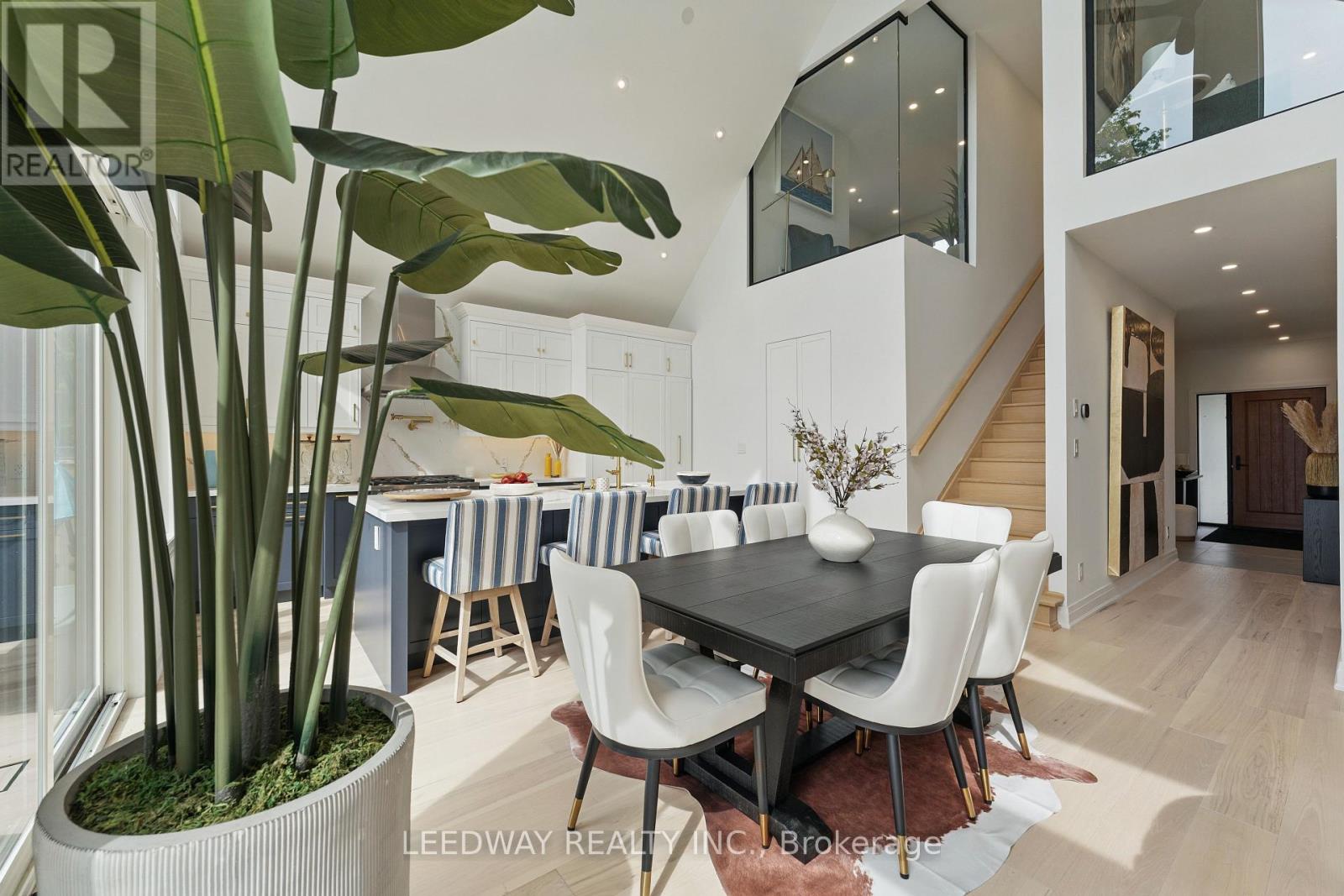 A modern dining room with a large table and chairs.