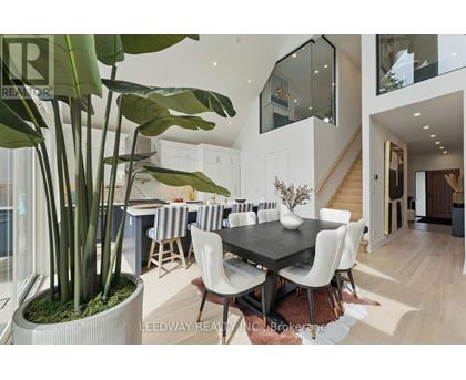 A modern dining room with a large table and chairs.