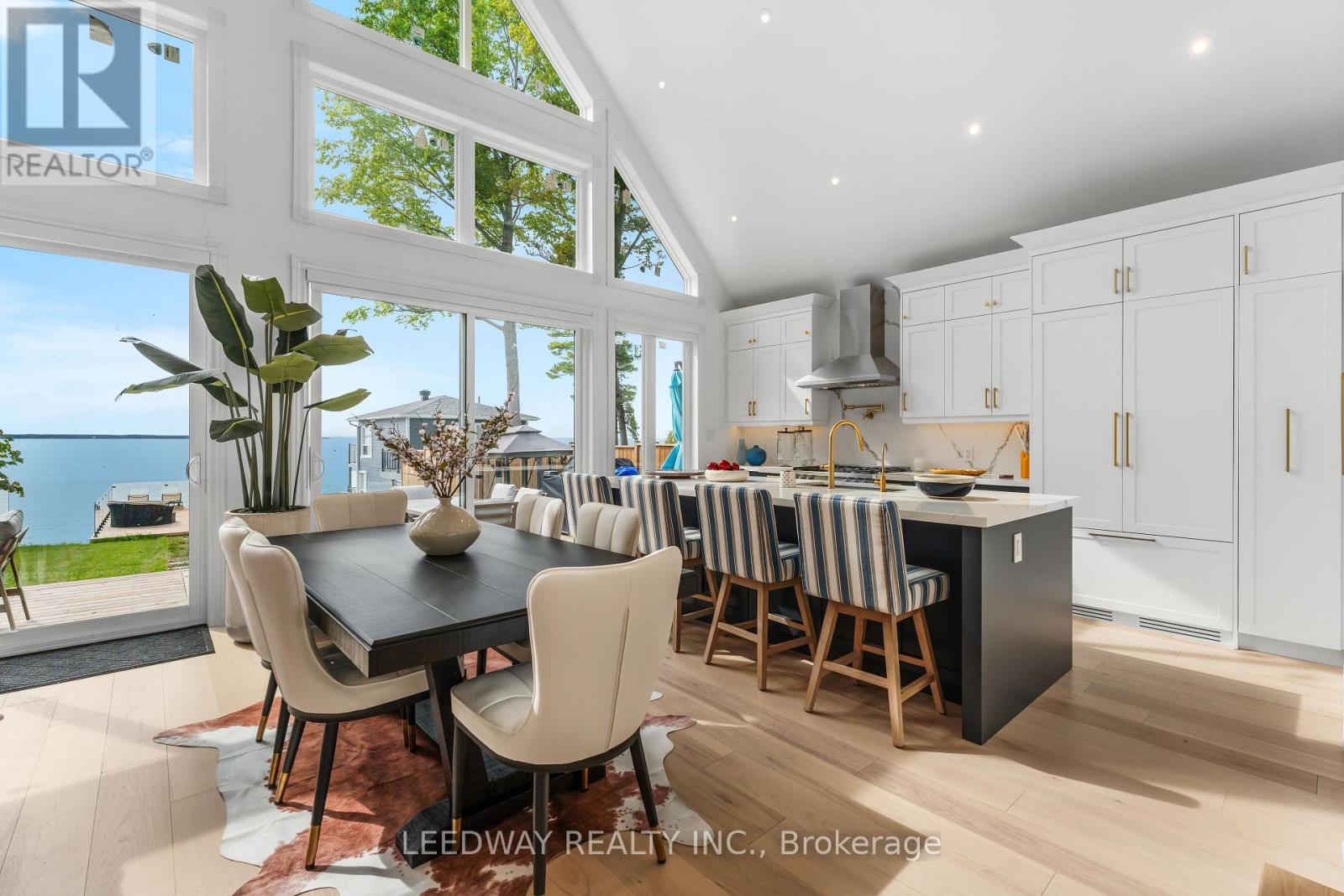 A modern kitchen with a dining table and chairs.
