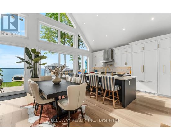A modern kitchen with a dining table and chairs.