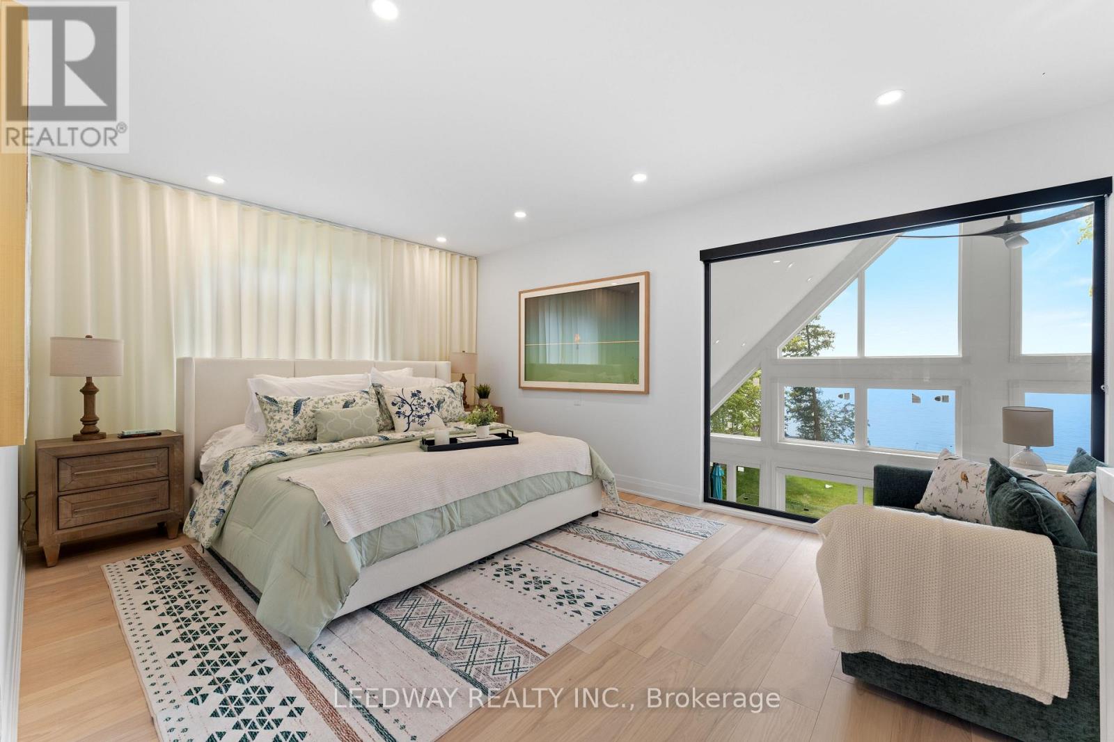 A bedroom with a large bed and a couch.
