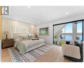 A bedroom with a large bed and a couch.