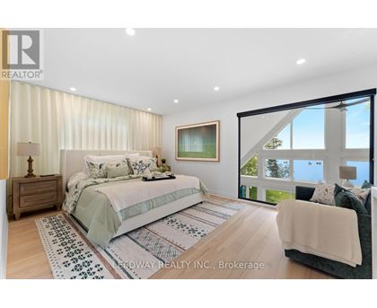 A bedroom with a large bed and a couch.