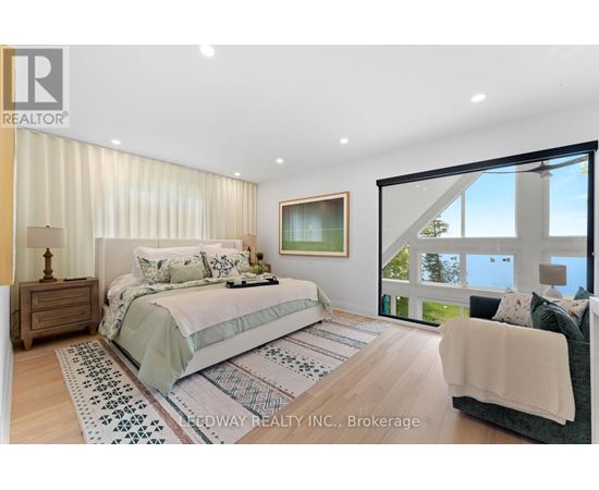 A bedroom with a large bed and a couch.