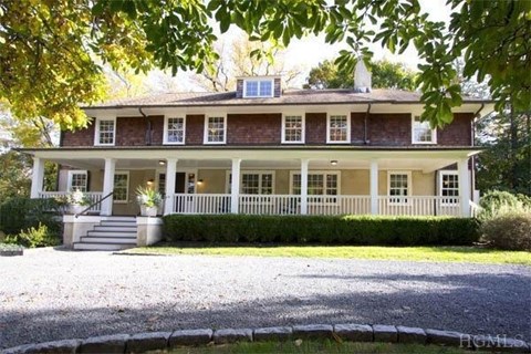 A house with a porch and a front yard.