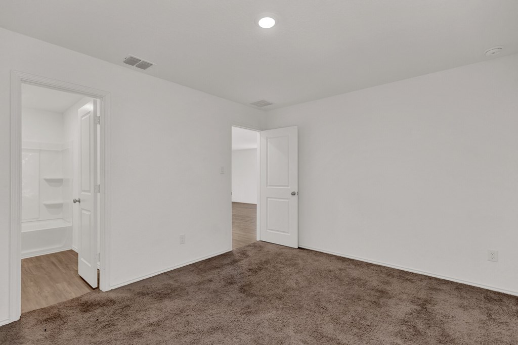A room with white walls and a carpeted floor.
