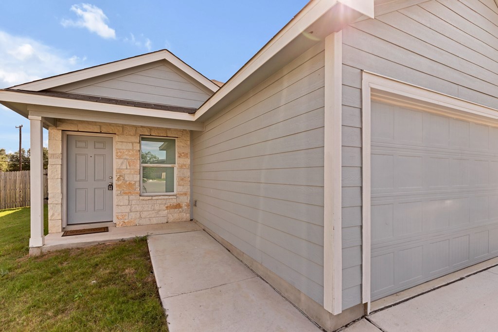 A house with a grey garage door and a grey front door.