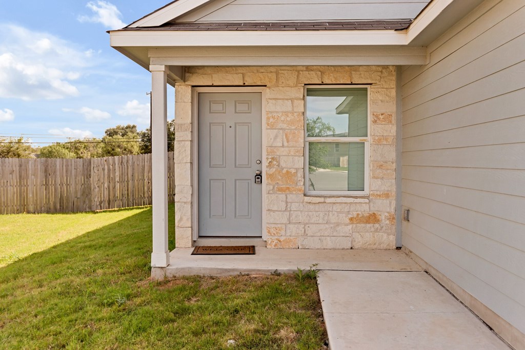 A house with a grey door and a small window.