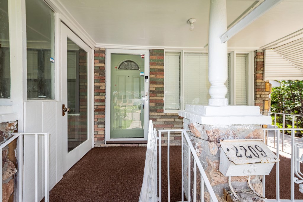 A white railing with a house number on it.
