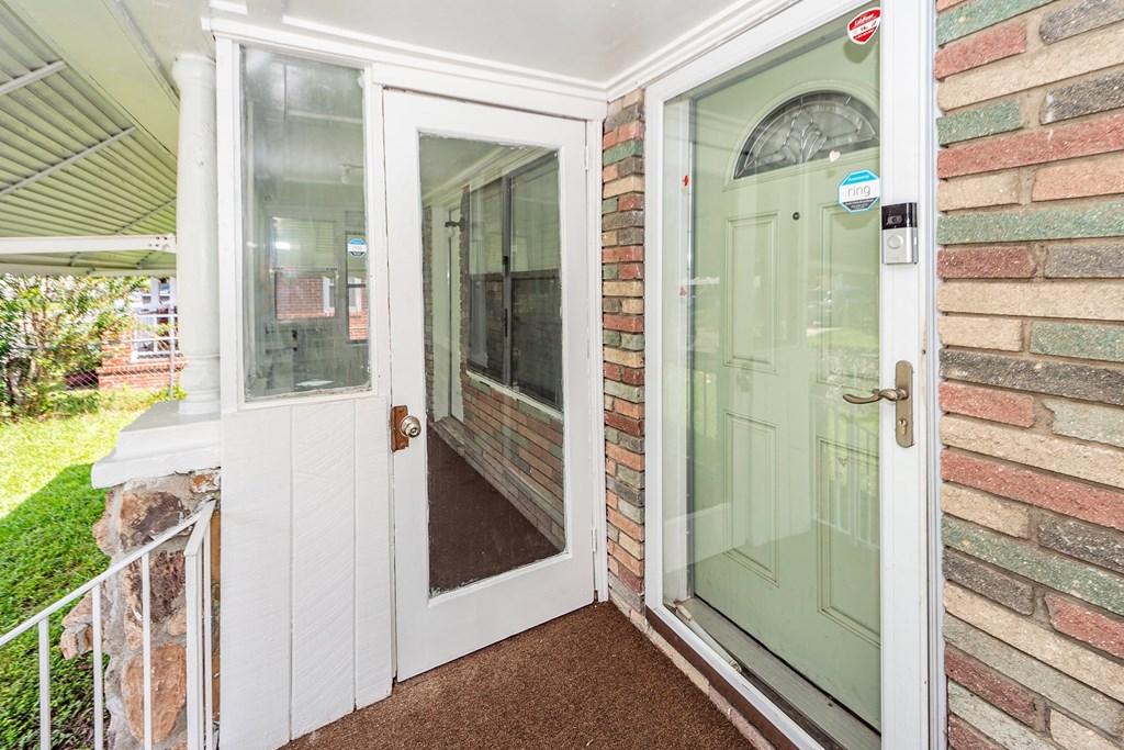 A white door with a glass window is open.