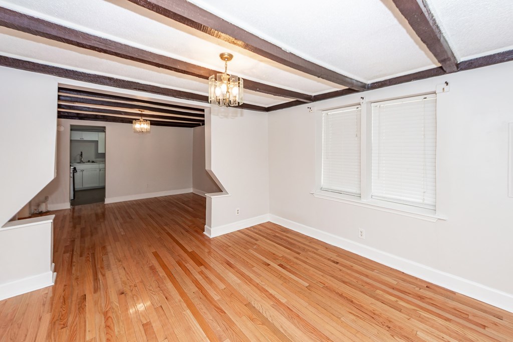 A room with wooden floors and white walls.