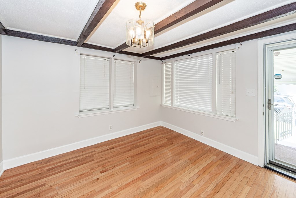 A room with wooden floors and a chandelier.