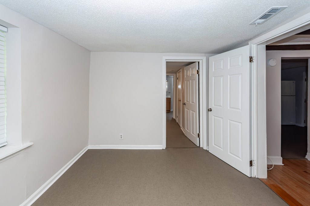 A room with white walls and a carpeted floor.