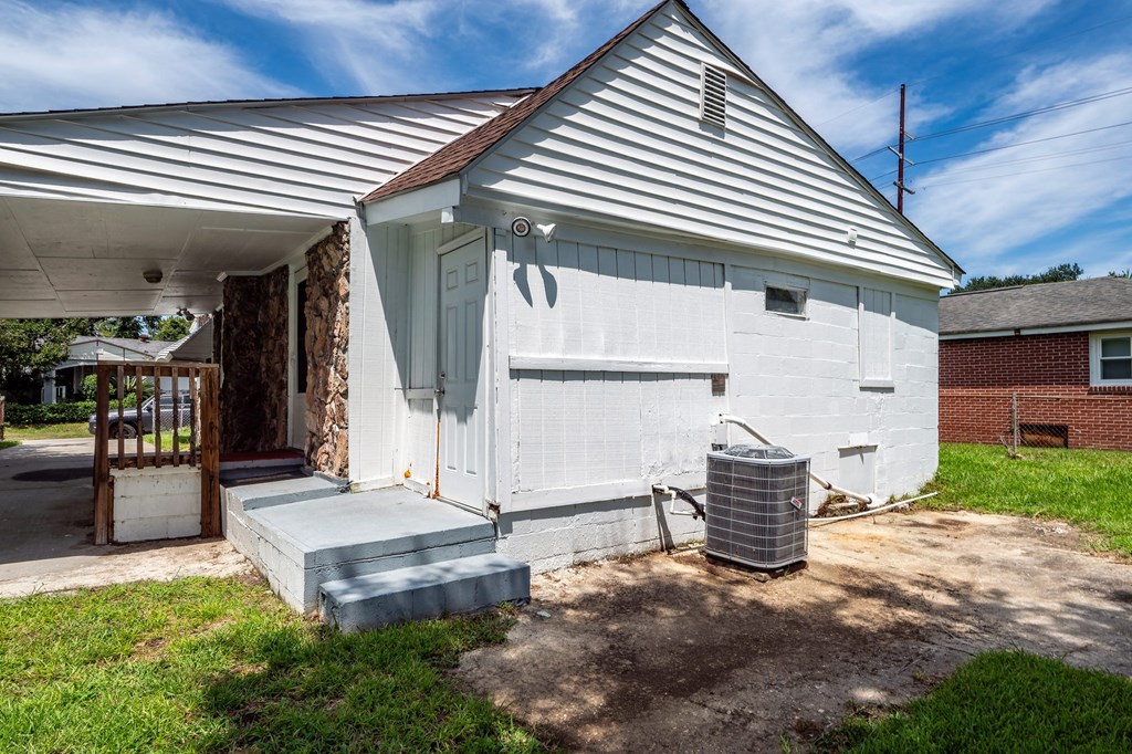 A white house with a porch and a door.