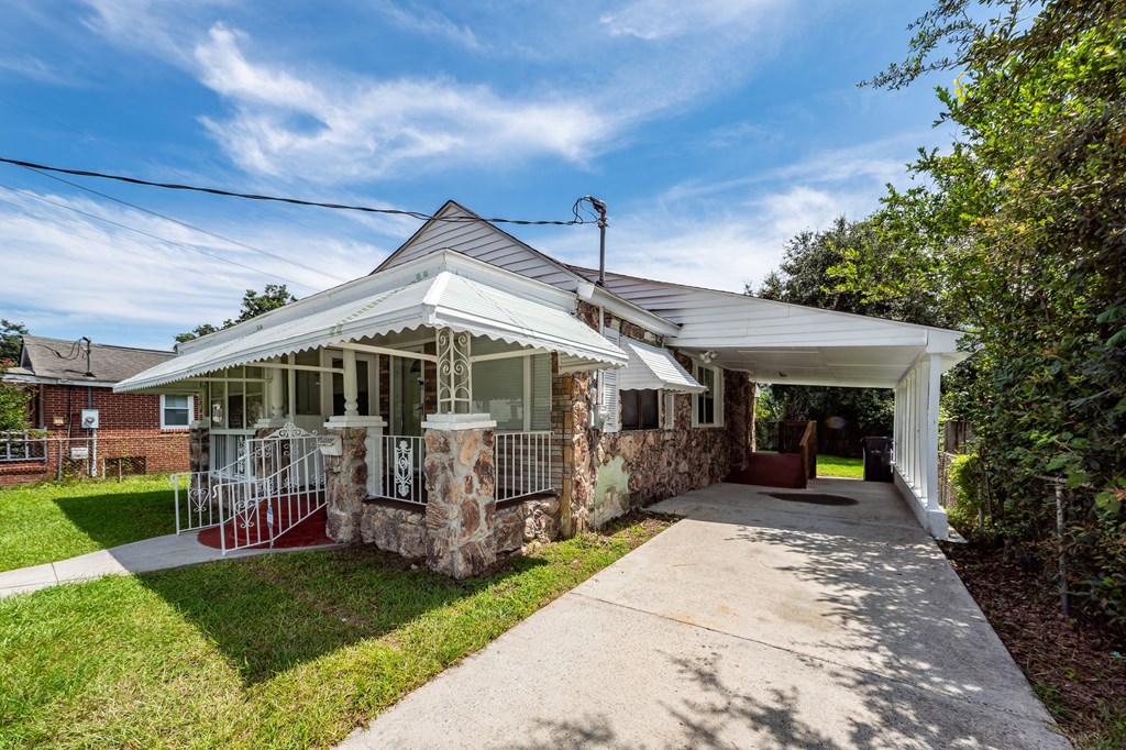 A house with a white porch and a covered walkway.