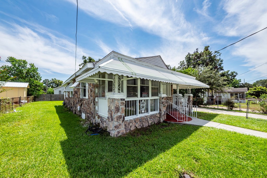 A house with a white porch and a red railing.