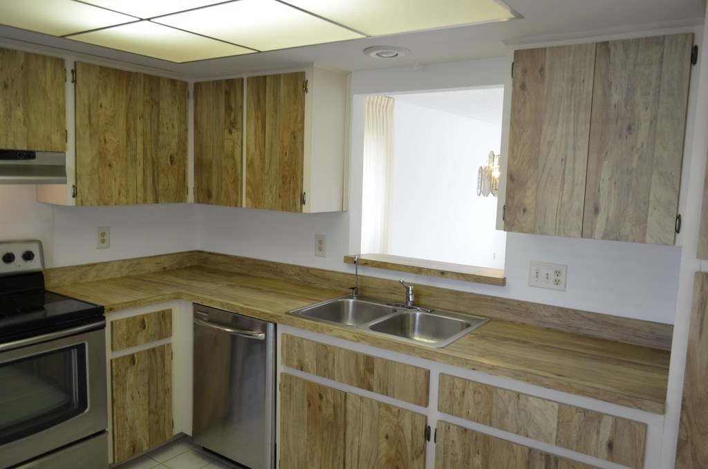 A kitchen with wooden cabinets and stainless steel appliances.