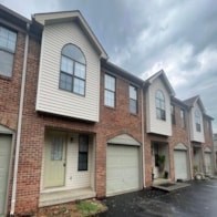 A row of houses with garages in front.