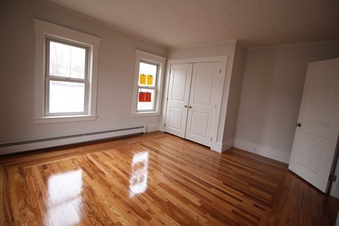 A room with wooden floors and white walls.