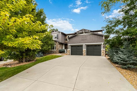 A house with a driveway and garage doors.