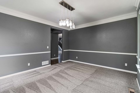 A room with grey walls and a carpeted floor.