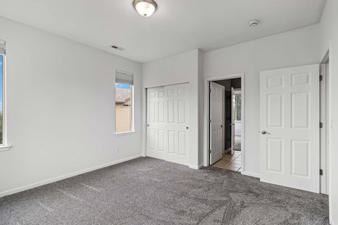 A room with white walls and a carpeted floor.