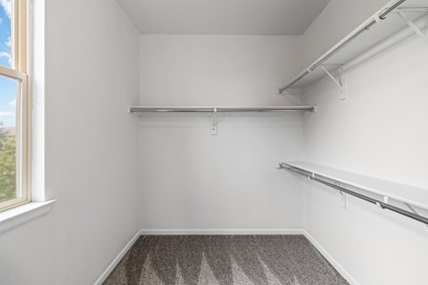 A room with a grey carpet and white walls.