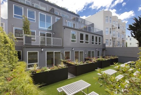 A modern apartment complex with a well-maintained outdoor area.