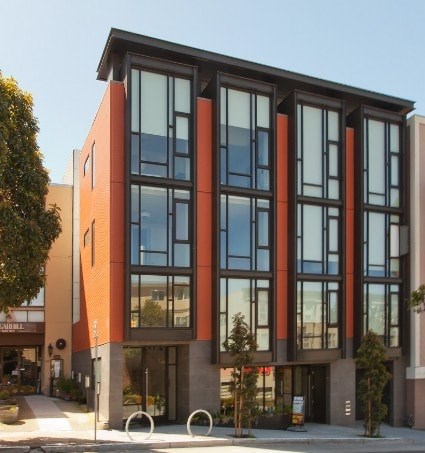 A modern building with a combination of orange and grey exterior.