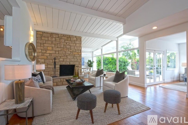 A living room with a stone fireplace and a couch.