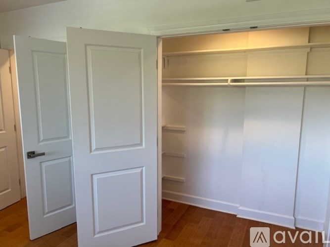 A white door is on the left and a white shelf is on the right.