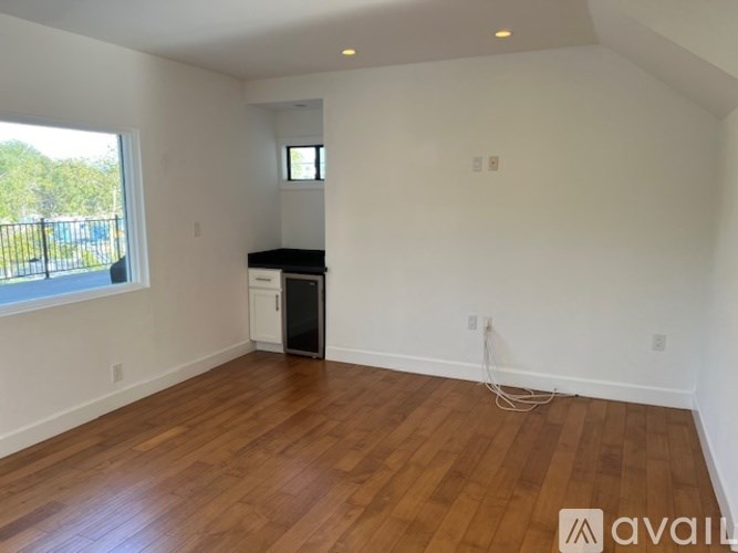 A room with wooden floors and a window.