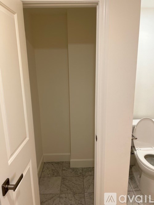 A bathroom with a toilet and a door.