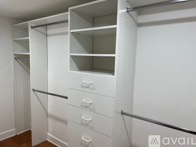 Closet with shelves and drawers in a room.