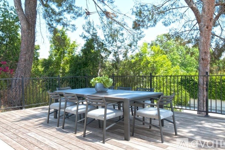 A table set for six with a vase of flowers on it.