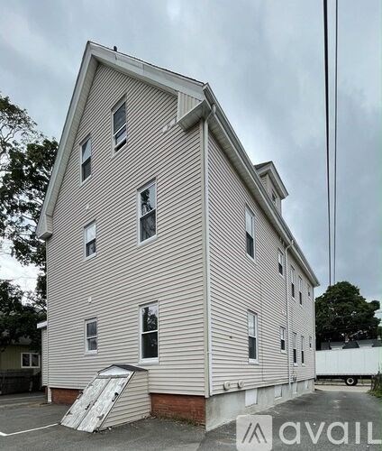 A two-story building with a white door and windows.