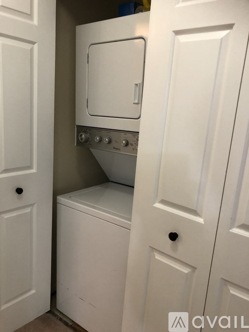 A white washing machine and dryer in a small laundry room.