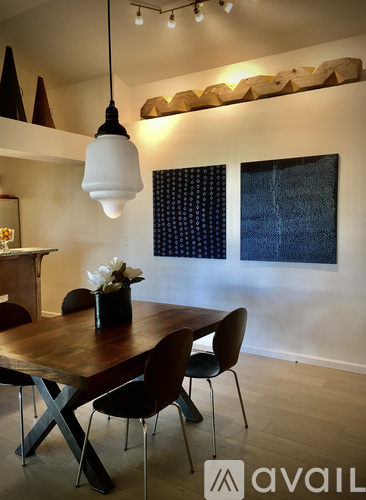 A dining room with a wooden table and chairs.