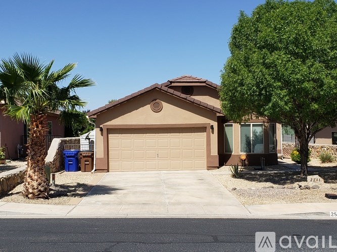 A house with a brown roof and tan garage door is for sale.