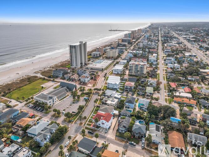 A coastal cityscape with a beach and buildings.