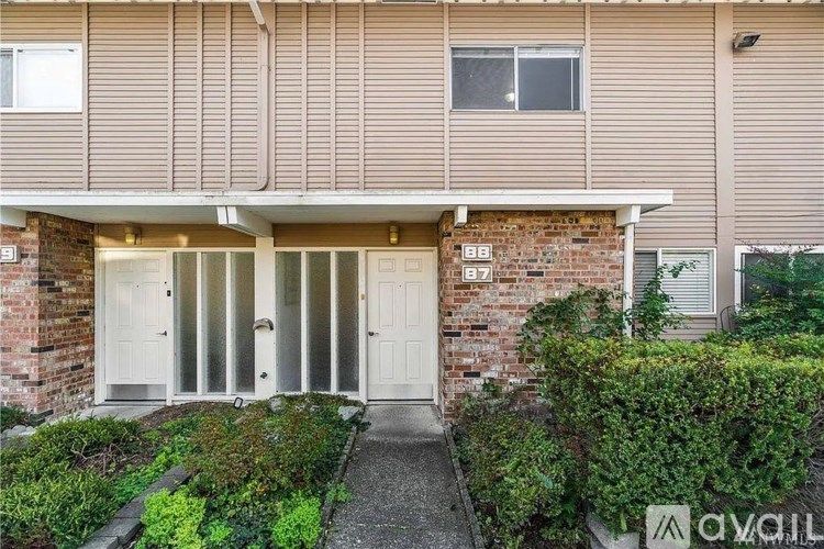 A house with a white door and windows is for sale.