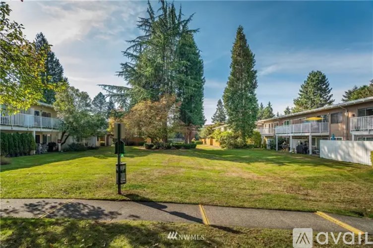 A grassy area with a signpost in the middle of it.