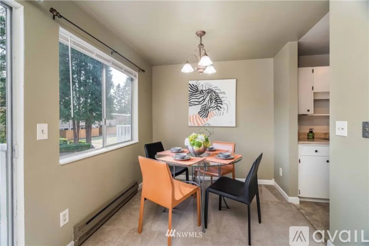 A dining area with a table and chairs is shown.