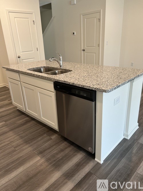 A kitchen with a granite countertop and a sink.