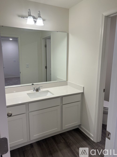 A bathroom with a sink and mirror.