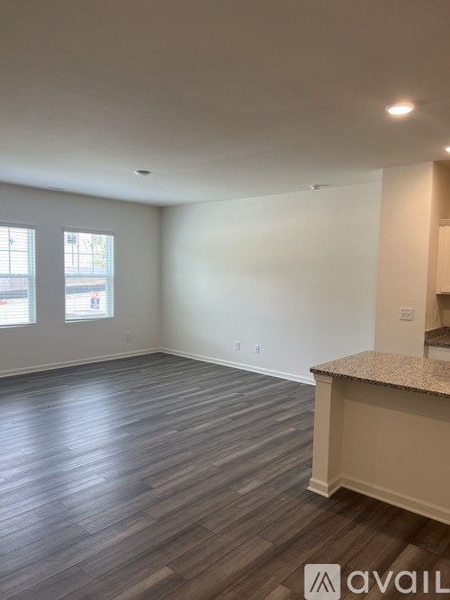 A room with wooden flooring and a counter.