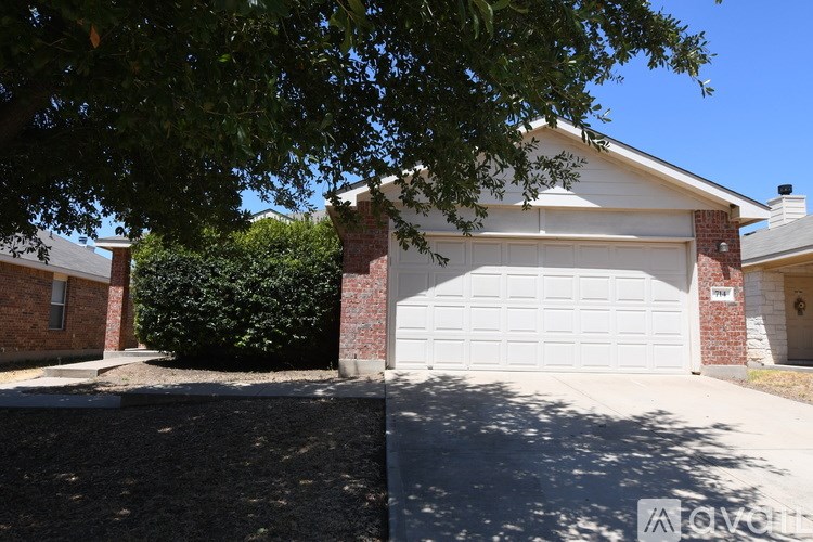A house with a white garage door and a brick chimney.
