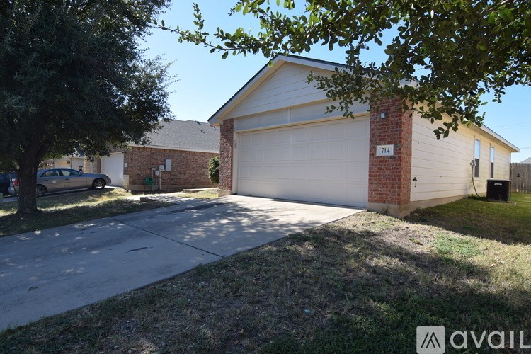 A two-car garage with a brick pillar and a white door.