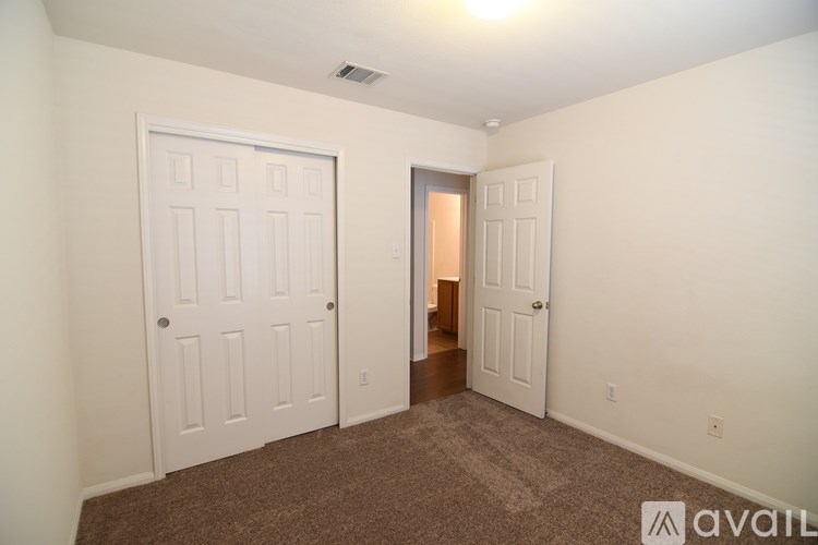 A room with two doors, one of which is open.