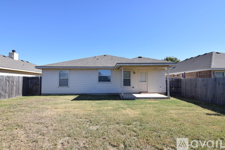 A room with carpeted floor and a skylight.